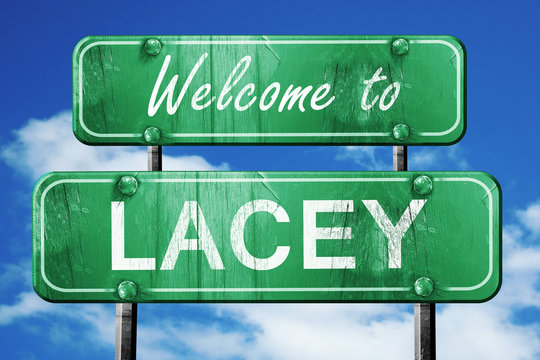 lacey vintage green road sign with blue sky background