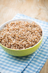 Buckwheat porridge in a bowl with mint leaves and blueberries.