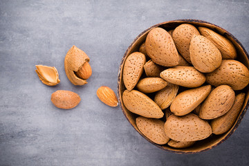 Group of almond nuts with leaves.Wooden background.