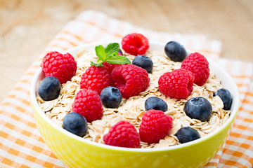 Fototapeta premium Oatmeal porridge with berries. Raspberries and blueberries.