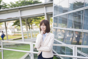 Fototapeta premium Attractive asian business woman smiling outside office