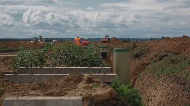 Excavator digging and moving earth at construction site
