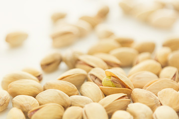 The pistachios on white background. The pistachio background.