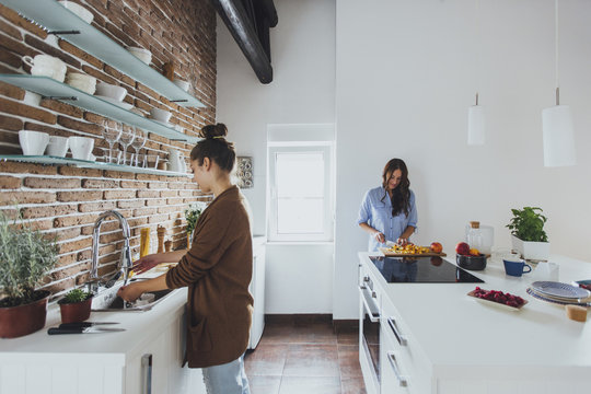 Caucasian women cooking in kitchen