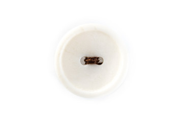 button with brown thread on white background