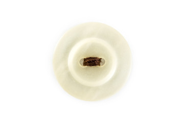 button with brown thread on white background
