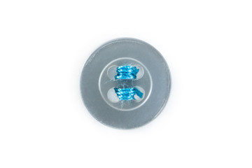 button with blue thread on white background