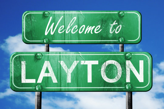 layton vintage green road sign with blue sky background