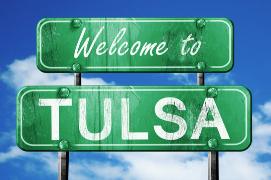tulsa vintage green road sign with blue sky background