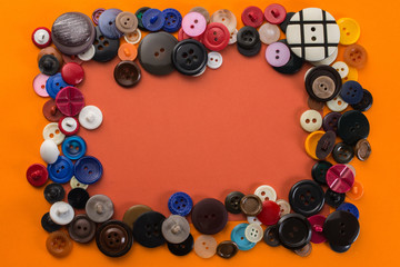 button and red sheet of paper on an orange background