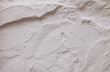 Vintage background with old white concrete wall and retro wallpaper fragments. Backdrop for your design