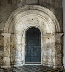 Fototapeta na wymiar Portal of old russian white stone church