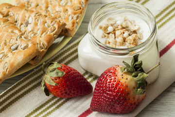 Breakfast of yogurt, muesli, berries and cookies