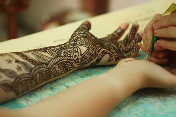 Process of applying Mehndi on female hand. Henna tattoo
