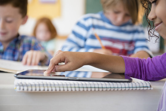 Student using digital tablet in classroom