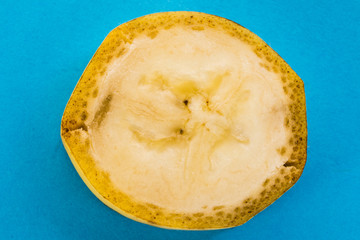 slice of banana on a blue background closeup