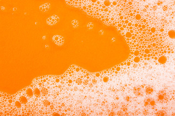 foam on orange background macro