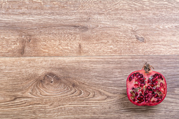 Cut pomegranate on a wooden background