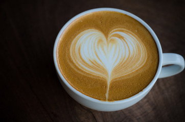 latte art coffee on wooden table