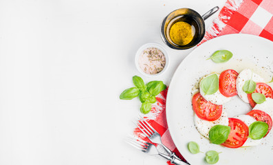 CLassic Italian Caprese salad with tomatoes, mozzarella di Buffala and fresh basil.