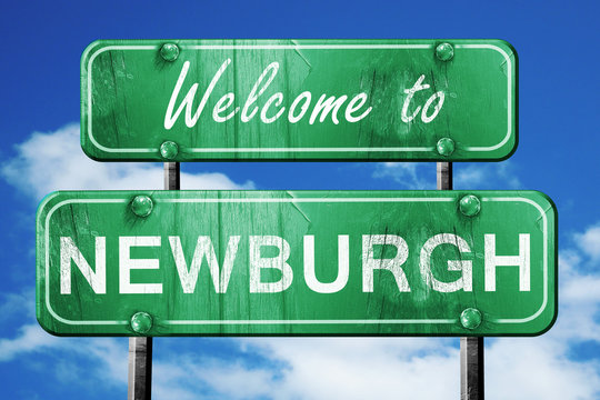newburgh vintage green road sign with blue sky background