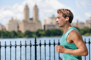 Man jogging in Manhattan Central Park during summer Male Caucasian runner running in New York City...