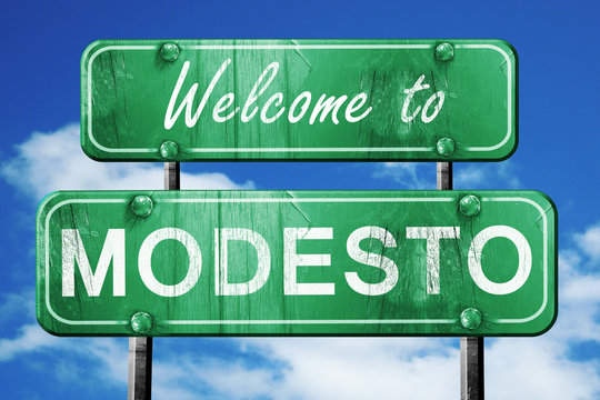 modesto vintage green road sign with blue sky background