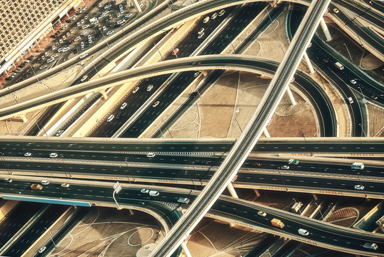 Aerial view of a highway junction with traffic in Dubai, UAE, at sunset. Sheikh Zayed road in Dubai.