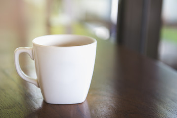 Cup of coffee on table in cafe Morning light , vintage tone.