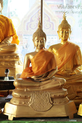 Close-up of golden meditating buddha statues in the temple,Thailand