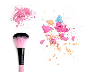 Close up of crushed blush on white background and cosmetic brush