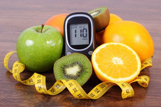 Glucometer with fresh fruits and centimeter, diabetes lifestyles and nutrition