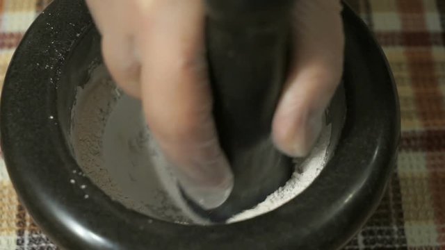 The grinding of the eggshell using mortar