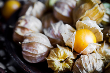 Closeup orange organic cape gooseberries on wooden background
