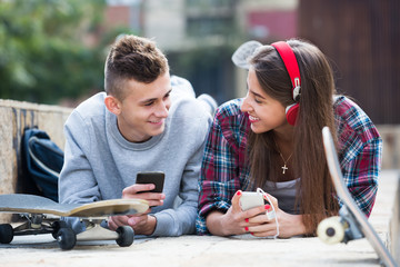 Teenager and his girlfriend with smartphones