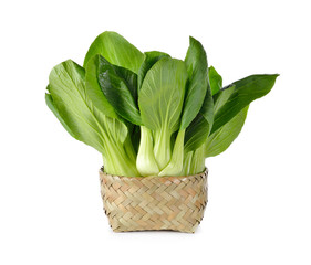 fresh baby Bok choy (Chinese cabbage) in bamboo basket on white