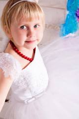 Portrait of beautiful princess girl in white dress with white ni