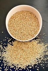 Quinoa in the bowl on the black background