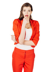 portrait of young business woman in red suit scared ,afraid and anxious looking to the camera, with wide opened eyes. isolated on white background. business and lifestyle concept