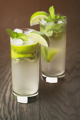 homemade mojito cocktail on wood table, vintage toned photo