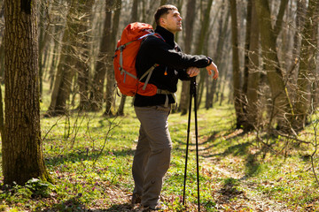 Active healthy man hiking in beautiful forest