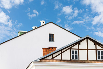 roofs of residential buildings against blue sky