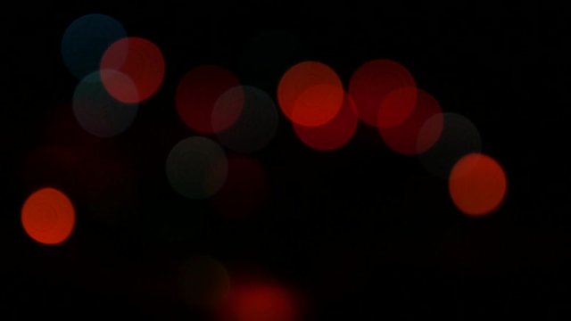 Colorful dot Christmas background lights defocused blinking 4K slow pan 2160p 30fps UHD video - Blinking in dark multi-color decorative dot lights 4K 3840X2160 UltraHD panning footage 