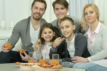 family at home with pizza