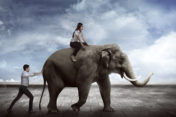 Fototapeta na wymiar Asian business man push elephant