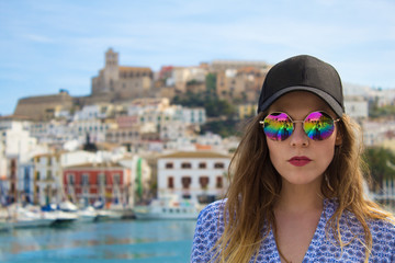 Young girl in sunglasses by the sea