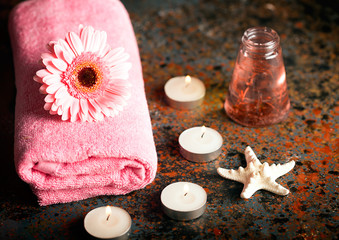 SPA still life with towel, candles and gerberas