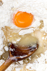 Raw egg in the flour macro shot