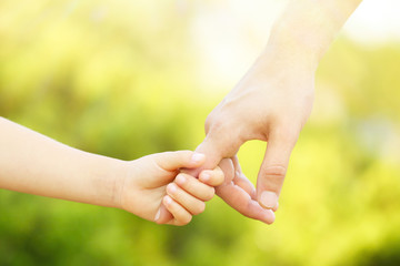 Father and daughter hands outdoors