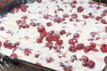 Cherries on the prepared dough ready for baking